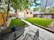The Backyard features a green lawn, an detached garage, patio, and privacy fence at 3259 Lowell Blvd, Denver, CO 80211