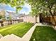 Backyard with green lawn, detached garage, privacy fence, and outdoor dining area at 3259 Lowell Blvd, Denver, CO 80211
