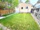 Beautiful backyard showcasing a well-manicured lawn, privacy fence, and detached garage at 3259 Lowell Blvd, Denver, CO 80211