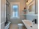 Bathroom featuring updated vanity, black plumbing fixtures, clawfoot tub, and hexagon tile floor at 3259 Lowell Blvd, Denver, CO 80211