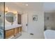 Bright bathroom featuring a modern vanity, bathtub, white tile, and neutral walls at 3259 Lowell Blvd, Denver, CO 80211