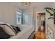 Cozy bedroom featuring hardwood floors, closet, neutral walls, and ample natural light at 3259 Lowell Blvd, Denver, CO 80211