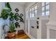 Inviting entryway featuring beautiful hardwood floors and a decorative glass front door with ample natural light at 3259 Lowell Blvd, Denver, CO 80211