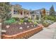 Lovely vintage brick home with a covered porch and professional landscaping, including a terraced brick planter at 3259 Lowell Blvd, Denver, CO 80211