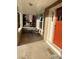Charming front porch with seating area, bright red door, and 'HOME' welcome mat at 3259 Lowell Blvd, Denver, CO 80211