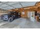 Spacious garage with exposed wood rafters providing ample parking and storage for vehicles and equipment at 3259 Lowell Blvd, Denver, CO 80211