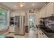 Bright kitchen with granite countertops, stainless steel appliances, and custom cabinets that offer ample storage at 3259 Lowell Blvd, Denver, CO 80211