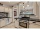 Bright kitchen boasting stainless steel appliances, dark granite countertops, and stylish tiled backsplash at 3259 Lowell Blvd, Denver, CO 80211