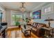 Cozy living room boasts refinished hardwood floors, vintage windows, and a comfortable leather sofa set at 3259 Lowell Blvd, Denver, CO 80211