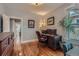 Functional home office space featuring hardwood floors, dark wood desk, and bright natural light at 3259 Lowell Blvd, Denver, CO 80211