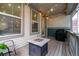 Cozy back porch area featuring a fire pit, grill, and string lights for outdoor entertaining at 9723 Bennett Peak St, Littleton, CO 80125