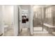 Modern bathroom featuring tiled floors and shower, with bedroom in background at 9723 Bennett Peak St, Littleton, CO 80125