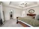 Bedroom featuring a bed, ceiling fan, and views of the bathroom and hallway at 9723 Bennett Peak St, Littleton, CO 80125