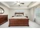 Bright bedroom showcasing a large wood bed frame, ceiling fan, and plenty of natural light at 9723 Bennett Peak St, Littleton, CO 80125
