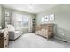 Serene Bedroom with crib, rocking chair, and soft green walls at 9723 Bennett Peak St, Littleton, CO 80125