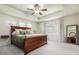 Spacious bedroom showcasing a large wood bed frame, ceiling fan, and plenty of natural light at 9723 Bennett Peak St, Littleton, CO 80125