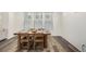Bright dining room with wood table set, light walls, and wood floors, perfect for Gathering meals at 9723 Bennett Peak St, Littleton, CO 80125