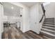 Inviting entryway with wooden floors that leads to the living spaces and staircase at 9723 Bennett Peak St, Littleton, CO 80125
