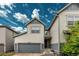 Charming townhouse with a two-car garage, brick driveway, and beautifully landscaped entrance at 9723 Bennett Peak St, Littleton, CO 80125
