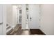 Bright foyer featuring stylish floors, a staircase, and a white front door at 9723 Bennett Peak St, Littleton, CO 80125
