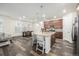 Spacious eat-in kitchen featuring a large island and stainless appliances adjacent to the living area at 9723 Bennett Peak St, Littleton, CO 80125