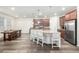 Eat-in kitchen featuring an oversized island, stainless appliances, and views to the dining area at 9723 Bennett Peak St, Littleton, CO 80125