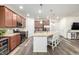 Spacious kitchen with stainless appliances, wine fridge, large island, and ample cabinet storage at 9723 Bennett Peak St, Littleton, CO 80125