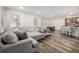 Open concept living room featuring modern floors that connects to the kitchen and dining area at 9723 Bennett Peak St, Littleton, CO 80125