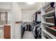 Large walk-in closet featuring custom shelving and plenty of hanging space at 9723 Bennett Peak St, Littleton, CO 80125
