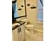 Stylish bathroom features a vanity with black marble, toilet, and window with natural light at 19102 E Hampden Dr, Aurora, CO 80013