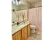 Bathroom with marble countertops and vanity, gold tree decoration, and light pink shower curtain at 19102 E Hampden Dr, Aurora, CO 80013