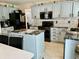 Stylish kitchen boasts gray cabinets, stainless steel appliances, granite countertops, and tile backsplash at 19102 E Hampden Dr, Aurora, CO 80013