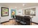 Basement wet bar with wooden counter, cabinets and decorative modern art at 3309 E 7Th Ave Pkwy, Denver, CO 80206