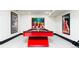Finished basement with a red billiard table, artwork, and neutral carpet at 3309 E 7Th Ave Pkwy, Denver, CO 80206