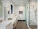 Bright bathroom featuring double vanity with white marble counters, marble tiled shower and floors at 3309 E 7Th Ave Pkwy, Denver, CO 80206