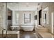 Bright bathroom with stand alone tub, large windows, white marble counters, and tiled shower at 3309 E 7Th Ave Pkwy, Denver, CO 80206