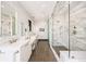 Bright bathroom featuring double vanity with white marble counters, marble tiled shower and floors at 3309 E 7Th Ave Pkwy, Denver, CO 80206