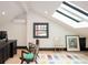 Bonus room with a skylight, hardwood floors, and modern furnishings at 3309 E 7Th Ave Pkwy, Denver, CO 80206