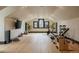 Bonus room with a hardwood floors, three windows, and exercise equipment at 3309 E 7Th Ave Pkwy, Denver, CO 80206
