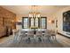 Stately dining room featuring a long table with seating for ten, modern lighting, and hardwood floors at 3309 E 7Th Ave Pkwy, Denver, CO 80206