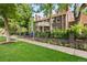 Beautiful brick home with a landscaped front yard, brick fence, wrought iron fence and a manicured lawn at 3309 E 7Th Ave Pkwy, Denver, CO 80206
