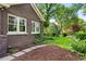 Lush front yard features a stone pathway, mature trees, and well-maintained landscaping around the property at 3309 E 7Th Ave Pkwy, Denver, CO 80206