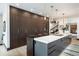 Contemporary kitchen with dark wood cabinets, wine fridge, kitchen island, and pendant lighting at 3309 E 7Th Ave Pkwy, Denver, CO 80206