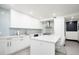 Bright kitchen featuring white marble counters, white cabinets, tiled backsplash and stainless steel appliances at 3309 E 7Th Ave Pkwy, Denver, CO 80206