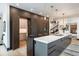 Modern kitchen with dark wood cabinets, a hidden pantry, kitchen island, and pendant lighting at 3309 E 7Th Ave Pkwy, Denver, CO 80206
