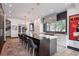 Bright kitchen with large windows, stainless steel appliances, island, and a modern chandelier at 3309 E 7Th Ave Pkwy, Denver, CO 80206