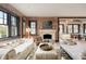 Spacious living room featuring brick accent wall, fireplace, plush seating, and modern decor elements at 3309 E 7Th Ave Pkwy, Denver, CO 80206
