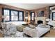 Stunning living room with brick walls, a fireplace, and plenty of seating for Gathering and friends at 3309 E 7Th Ave Pkwy, Denver, CO 80206
