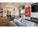 Open-concept living space with gas fireplace, comfortable seating and a modern kitchen in the background at 3309 E 7Th Ave Pkwy, Denver, CO 80206