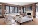 Bright living room with large windows, brick accent wall, fireplace, and cozy seating arrangement at 3309 E 7Th Ave Pkwy, Denver, CO 80206